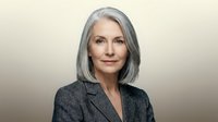 Senior woman with gray hair and fair complexion wearing charcoal blazer, professional headshot for corporate, business, and executive portraits.