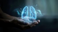 Digital holographic lungs floating above open hands with glowing particles and light effects representing respiratory health and medical technology concepts.