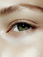 Close-up of green eye with natural makeup and groomed eyebrow. Clean beauty concept for skincare, cosmetics and wellness applications.