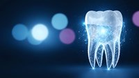 Glowing digital tooth with luminous particles on dark blue background for dental technology and healthcare innovation concepts.