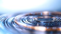 Concentric ripples on water surface with golden light reflections creating mesmerizing circular patterns against blue background, abstract macro photography.