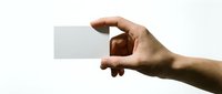 Hand holding blank white business card mockup on light background for branding and corporate identity design projects.
