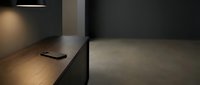 Modern minimalist office interior with wooden desk, concrete floor, and dark walls, suitable for corporate backgrounds and workspace design projects.