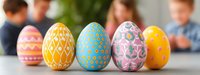 Colorful decorated Easter eggs in row with geometric and floral patterns on blurred background. Traditional spring holiday celebration symbols.