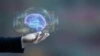 Businessman hand holding glowing digital brain with holographic neural network interface and data visualization elements for artificial intelligence and technology concepts.