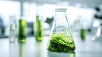 Laboratory flask with green liquid sample in modern research facility for scientific experiments and chemical analysis.