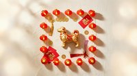 Red and gold decorative lanterns arranged in a square frame around a golden horse figurine on white surface, suitable for lunar new year celebrations and festive holiday designs.