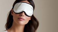 Young Asian woman wearing white sleep mask against neutral beige background, wellness and beauty concept for relaxation and rest.