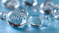 Transparent water droplets with air bubbles on blue surface, creating fresh, clean appearance for cosmetic, scientific, or environmental concepts.