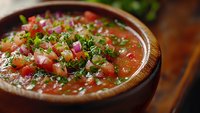 Fresh homemade salsa with diced tomatoes, onions and cilantro in rustic wooden bowl. Traditional Mexican appetizer ready for chips and tacos.