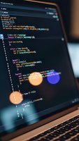 Programming code on laptop screen with colorful syntax highlighting and bokeh lights overlay for web development and software engineering projects.