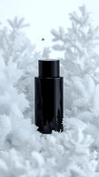 Black cosmetic bottle surrounded by delicate white frost crystals and winter foliage creates luxurious cold season skincare concept against soft gray background.