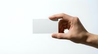 Hand holding blank white business card mockup on clean background for branding and corporate identity design projects.