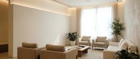 Modern minimalist living room with beige furniture, natural lighting and indoor plants creating warm contemporary interior design for home decor.