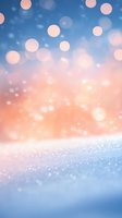 Dreamy winter background with soft pink and blue bokeh lights floating over sparkling snow surface, creating magical festive atmosphere for holiday designs.