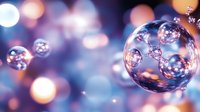 Macro shot of transparent soap bubbles floating against blurred bokeh background in blue and pink tones, creating dreamy atmospheric effect.