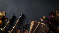 Vintage brass telescope with antique compass and autumn leaves on dark slate background for exploration and adventure themes.