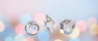 Clear crystal geometric shapes sphere pyramid cube on soft pastel background with bokeh lights for luxury jewelry design meditation spiritual decor.