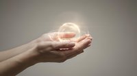 Hands holding glowing orb of light against neutral background, symbolizing innovation, energy, and future technology concepts for business and design projects.