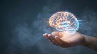 Human hand holding glowing brain with digital connections representing artificial intelligence, machine learning and neuroscience concepts.