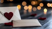 Romantic love letter with glitter heart and bokeh lights on dark background. White envelope and red decorative hearts create intimate Valentine mood.