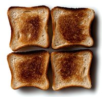 Four square pieces of golden-brown toast arranged symmetrically on white background, showing varying degrees of toasting and crispy texture, isolated for easy use in design.