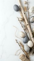 Easter eggs in neutral tones with pussy willow branches and natural decorations on white background for spring holiday celebration and seasonal design.