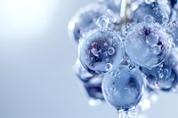 Crystal clear water bubbles with droplets creating abstract liquid formations on soft blue gradient background for refreshing design concepts.