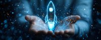 Glowing blue rocket hologram floating above open hands against dark background with sparkles and bokeh lights, symbolizing business startup and innovation.