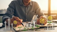Business professional analyzing sustainable investment growth with golden coins, green plants and rising charts on desk during golden hour.