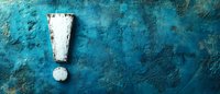 White exclamation mark painted on rustic turquoise blue concrete wall background with grunge texture and copy space for text or design.