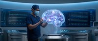 Male doctor in surgical scrubs examining holographic brain projection in futuristic medical control room with digital displays and advanced technology interface.