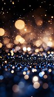 Magical glowing bokeh lights on dark background with golden and blue sparkles creating dreamy atmospheric effect for festive holiday designs.