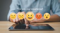 Customer feedback rating concept with hand selecting happy emoji from satisfaction survey on digital tablet for service quality evaluation.