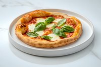 Traditional Neapolitan margherita pizza with melted mozzarella, tomato sauce and fresh basil leaves served on white ceramic plate against marble background.