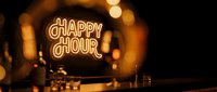 Neon happy hour sign glowing in warm orange light with blurred bar background creating cozy nightlife atmosphere for restaurant and pub promotions.