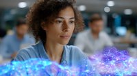 Young mixed race woman in office setting with glowing blue and purple digital hologram visualization, representing future technology and innovation in workplace environment.