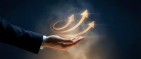 Business professional hand holding glowing upward arrows symbolizing growth, success and progress in corporate environment for presentations.