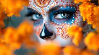 Young woman with sugar skull face art makeup and blue eyes surrounded by orange autumn leaves, creative Halloween or Day of Dead concept makeup design.