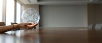 Hands holding glowing digital globe with network connections in modern office boardroom for global business technology concepts.