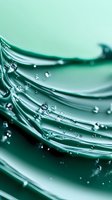 Macro photography of water drops on curved green surface creating abstract waves and lines with bokeh effect and transparent liquid droplets.