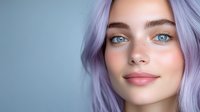 Young woman with lavender purple hair and blue eyes showcasing natural makeup and glowing skin for beauty and fashion concepts.