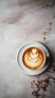 Cup of cappuccino with latte art in white ceramic cup on marble surface, viewed from above. Perfect for cafe menu or coffee blog.