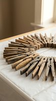 Vintage wooden clothespins arranged in a curved row on a white surface, showcasing rustic texture and warm brown tones in a cozy home setting.