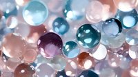Colorful translucent spheres in blue, pink, and purple tones creating dreamy bokeh effect, perfect for abstract backgrounds in design projects.