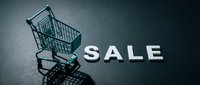 Mini shopping cart beside bold SALE letters on dark background, casting dramatic shadows, evoking retail discount and seasonal promotion concepts.
