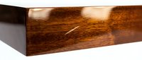 Rich mahogany wood block with glossy finish isolated on white background for carpentry and woodworking projects.
