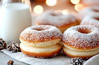 Fresh powdered sugar donuts with creamy vanilla filling on white surface, soft bokeh lights in background, close-up view with selective focus and festive winter decor.