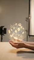 Hand holding glowing geometric shapes and sparkling light particles floating above palm, representing wealth, success, innovation, and digital transformation for business concepts.