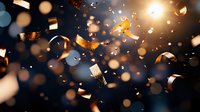 Glowing golden confetti and ribbons floating in dark space with bokeh light effects and sparkles creating festive celebration atmosphere.